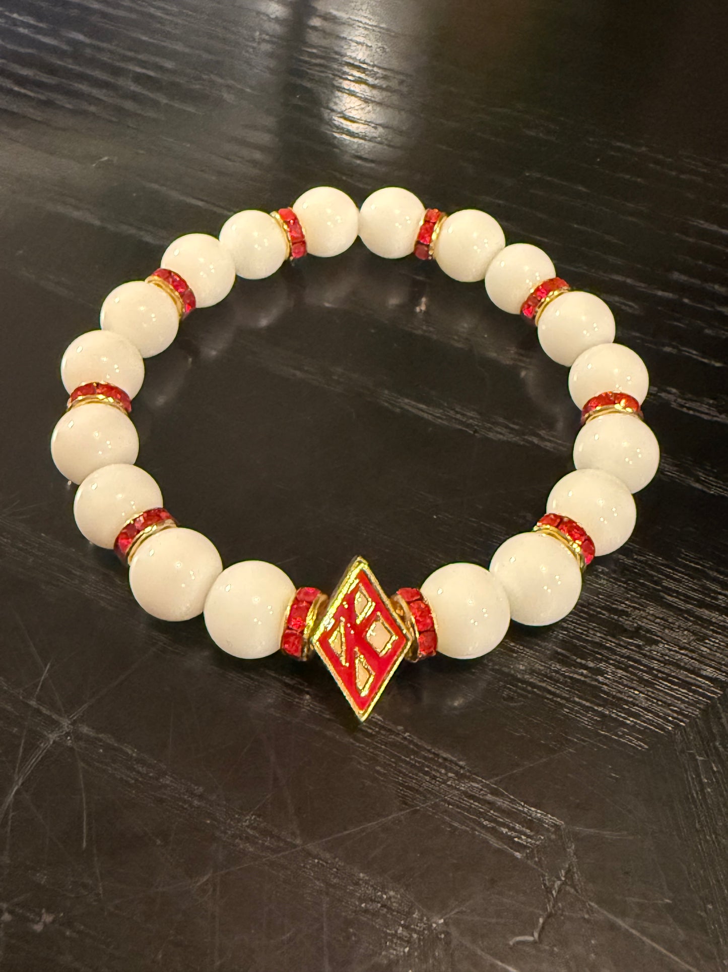 Floating "K" white beaded bracelet