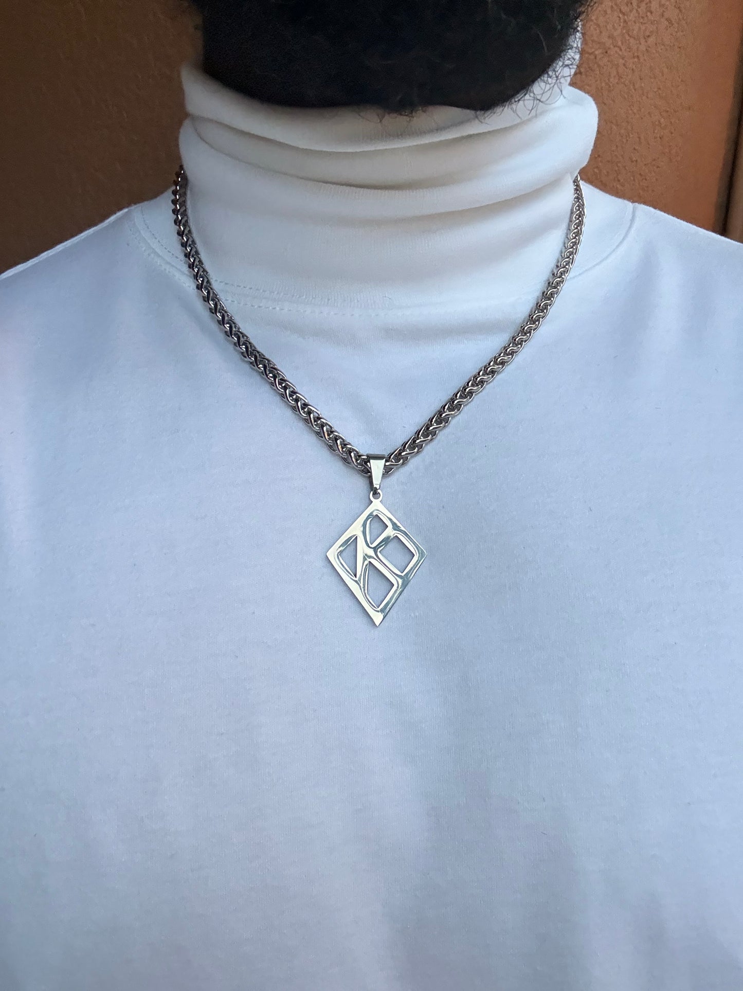 Floating K Stainless steel pendant on wheat chain