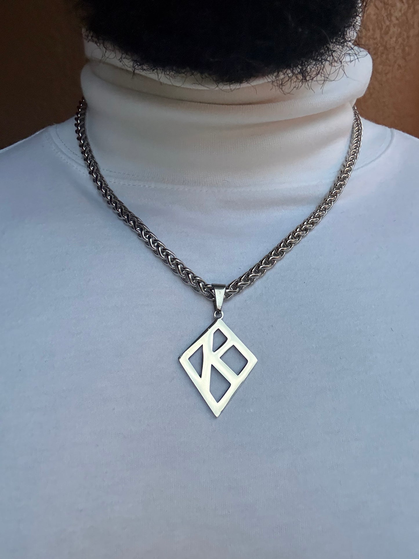 Floating K Stainless steel pendant on wheat chain